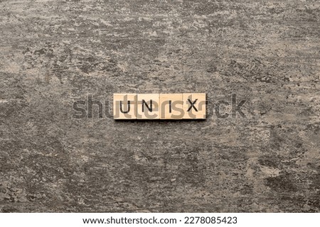 Unix word written on wood block. Unix text on table, concept.