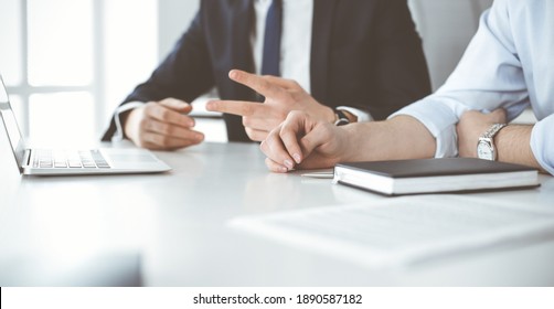 Unknown business people using laptop computer at the desk in modern office. Businessman or male entrepreneur is working with his colleague. Teamwork and partnership concept - Shutterstock ID 1890587182