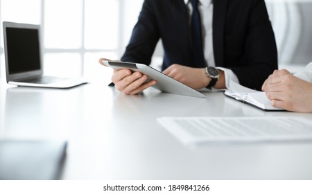 Unknown business people using tablet computer in modern office. Businessman or male entrepreneur is working with his colleague at the desk - Shutterstock ID 1849841266