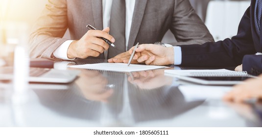 Unknown business people working together at meeting in modern office, close-up. Businessman and woman with colleagues or lawyers discussing contract at negotiation - Shutterstock ID 1805605111