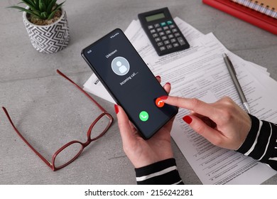 Unknown Caller. A Woman Holds A Phone In His Hand And Thinks To End The Call. Incoming From An Unknown Number. Incognito Or Anonymous. Businesswoman Can't Take The Call Because She Is At Work.