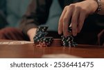 Unknown Caucasian business man guy businessman gamer male hand palm fingers touching counting poker chips tokens playing cards indoor living room or casino bar gambling game victory strategy addiction