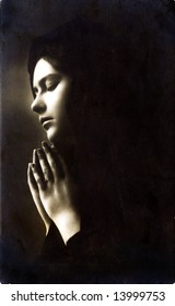 UNKNOWN - CIRCA 1900: An unidentified woman prays in this circa 1900s image.