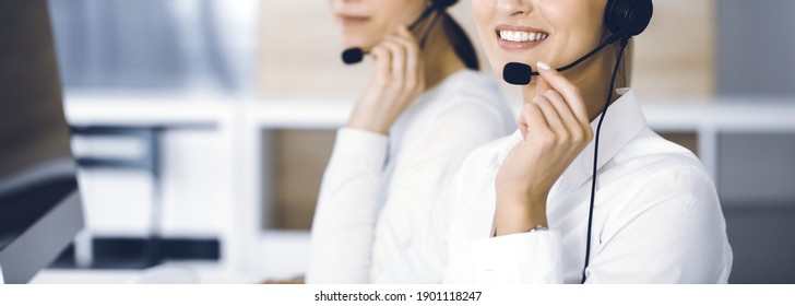 Unknown female customer service representative is consulting clients online using headset.close-up. Call center and business concept - Shutterstock ID 1901118247