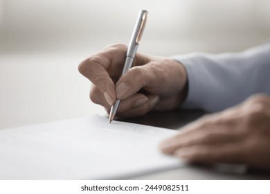 Unknown female hand holding pen and signing legal contract agreement, buying or selling services, make profitable business transaction, put signature of testament, affirming document. Successful deal - Powered by Shutterstock