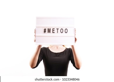 Unknown Female Holding Glowing Lightbox W/ '#Metoo' Hashtag Word. Me Too Movement Black Font Letters, Light Box. Anti Sexism Protest Against Inappropriate Behavior Towards Women. Close Up, Background.