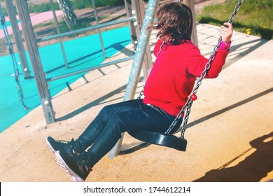 Unknown Gender.A Little Girl Rides On A Swing