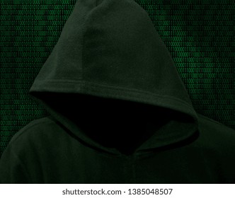 Unknown in the hood on a background of binary digits