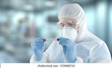 Unknown Laboratory Assistant Wearing Protection Gear Examines Vial With Anthrax Blood Test