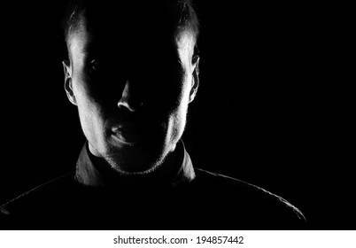 Unknown  male person silhouette.Back lit studio isolated