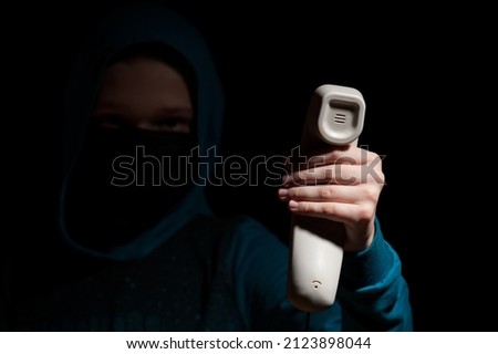 Unknown person with covered face makes an anonymous call intimidating and threatening the interlocutor