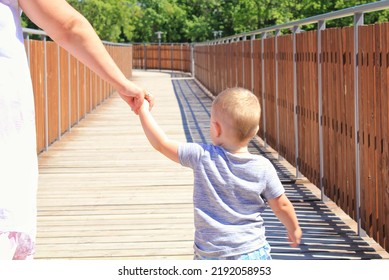 An Unknown Woman Takes The Little Boy Away From The Playground. Kidnapping Children On A Street Concept. Violence, Crime, Abuse, Abduction. Danger, Protection, Safety Baby Child. Social World Problem