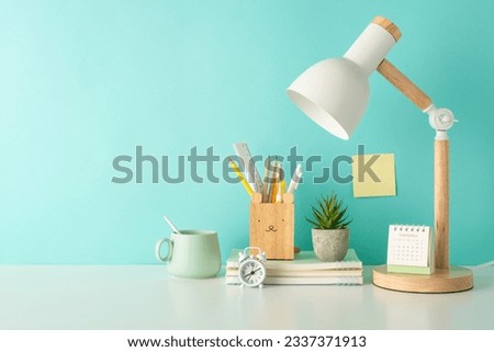 Unleash the spirit of fun learning with a side-view photograph displaying a variety of school supplies in organizer, notepads and desk lamp on a teal isolated background, perfect for text or advert