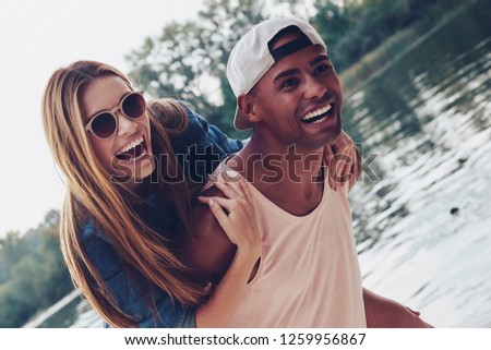 Unleashed fun. Beautiful young couples spending carefree time while standing on the pier