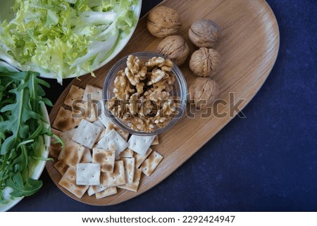Unleavened bread, fresh vegetables, dried fruits. Healthy food on a dark background with space for copy.
