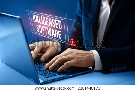Unlicensed software concept. Businessman gets warning about unlicensed software on his computer