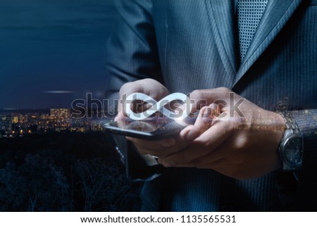 Unlimited Internet in tablet businessman on the background of night city.