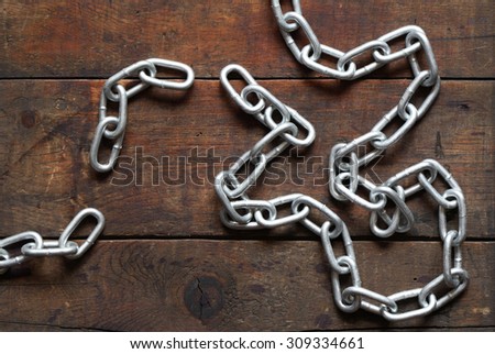 Unlinked metal chain on nice old wooden background