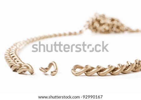 Unlinked part of the chain with twisted part o the other side, isolated against white background. small depth of field