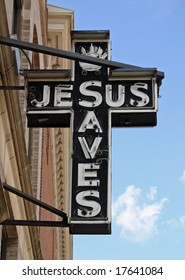 An unlit neon sign reading Jesus Saves