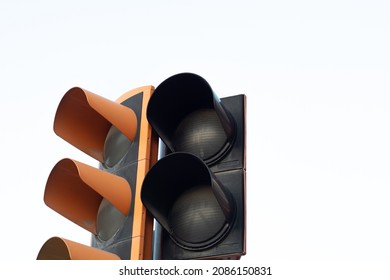 Unlit traffic light. Pedestrian crossing without active light. Traffic lights on white background. Traffic light not working and copy space. Traffic problem at intersections.