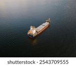 Unloaded cargo vessel in the Baltic sea, aerial drone point of view. 