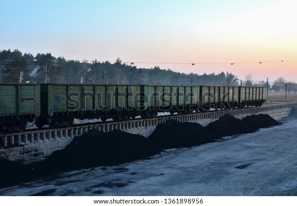 \
Unloading of crushed stone a railway car of a dump truck. Unloading\
bulk cargo from railway wagons on high railway\
platform