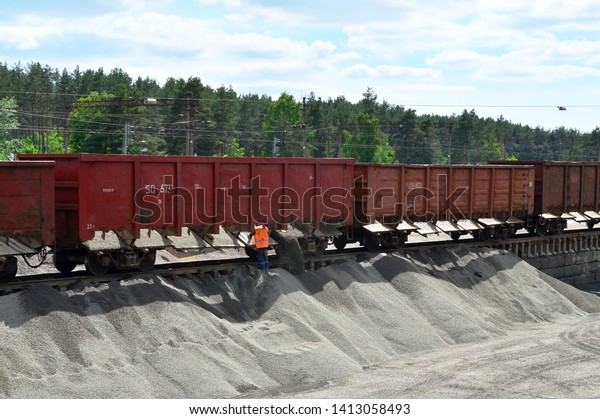  Unloading of crushed stone from railway car.\
Unloading bulk cargo from railway wagons on of high railway\
platform. Work with bulk\
cargo.