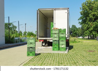Unloading food crates from a van. Delivery of goods to shops and cafes - Shutterstock ID 1781171132