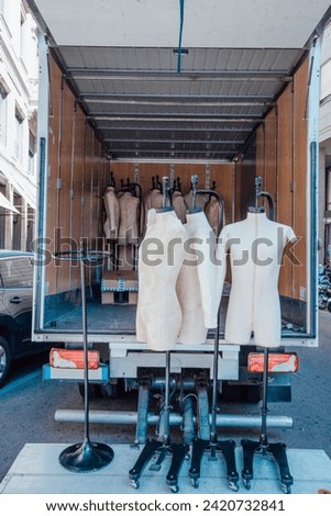 Unloading male mannequins from a truck for publication, design, poster, calendar, post, screensaver, wallpaper, cover, website. High quality photography