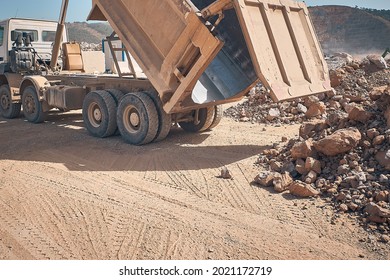 Unloading Tipper. Earthmoving Works At Construction Site. Dump Truck Unloads Soil From Truck Back