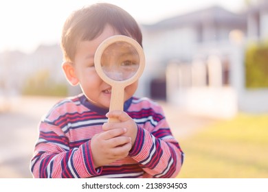 Unlock Brain Potential In Kid.Boy Child  Hands Holding Magnifying Glass For Find Searching Discover.Smart Brain Education DNA,Foster Child Find Parent Family.Imitation Behavior In Toddler Kid.daycare.