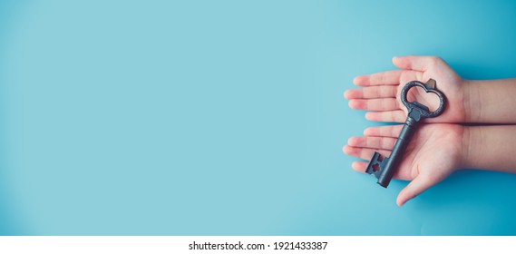 Unlock brain potential in kid.Child girl hands holding Key.Key for safety, Lock, Unlock, Security, secret, DNA, Success, Entrance, Protect kid and children.Child development education.Child rights.crc - Shutterstock ID 1921433387
