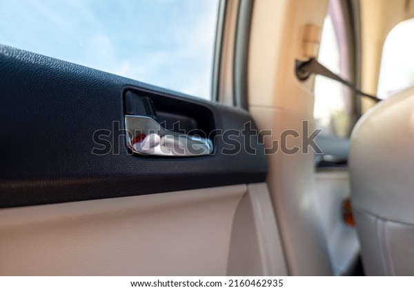 Unlock the car door, Unlock  open the door\
, Behind the seat, Inside the car, Beside the door, Inside the car\
concept. View from behind in the car\
seat.