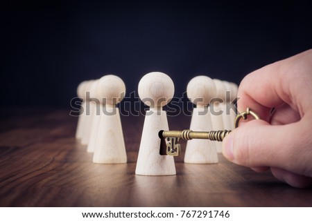 Unlock potential - motivational concept. Manager (HR specialist) unlock leader potential represented by figurine and hand with key.