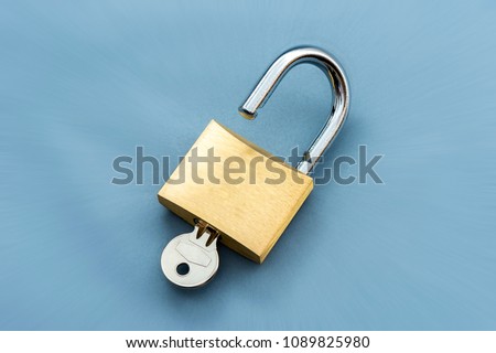 Unlocked Padlock and key on the blue background.