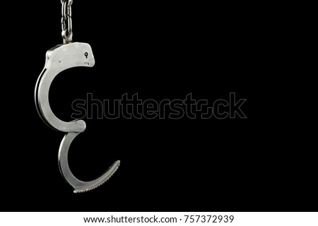Unlocked police handcuffs on a black background with text / writing / copy space