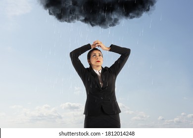 Unlucky Businesswoman With A Black Cloud Full Of Rain Over Her Head