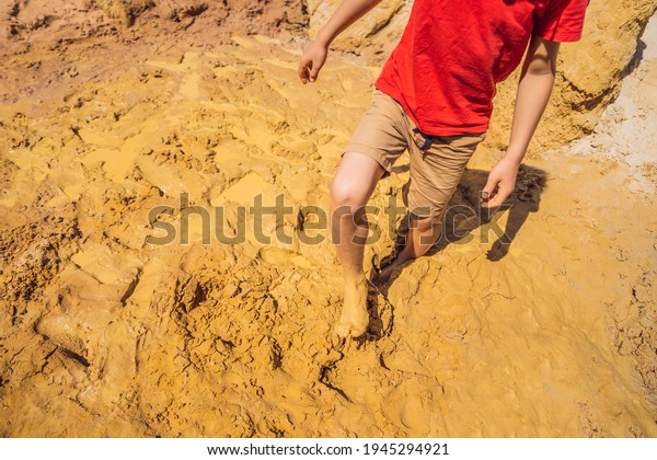 Unlucky person standing in natural quicksand\
river, clay sediments, sinking, drowning quick sand, stuck in the\
soil, trapped and stuck\
concept