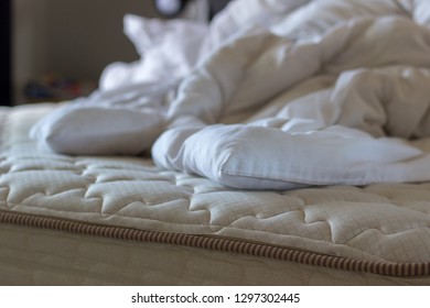 Unmade Bed With Duvet Inner And Pillows 