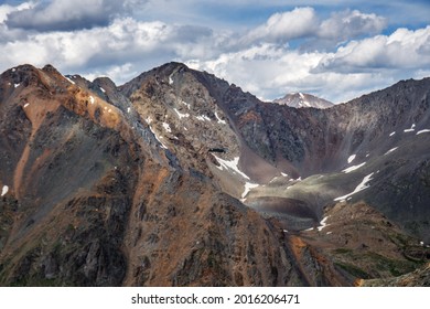 Unmanned aerial vehicle with a radio-controlled camera or UAV (unmanned aerial vehicle) in the mountains of the Altai Republic. Top view of the snowy peaks.