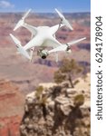 Unmanned Aircraft System (UAV) Quadcopter Drone In The Air Over The Grand Canyon.