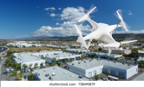 Unmanned Aircraft System (UAV) Quadcopter Drone In The Air Over Commercial Buildings.