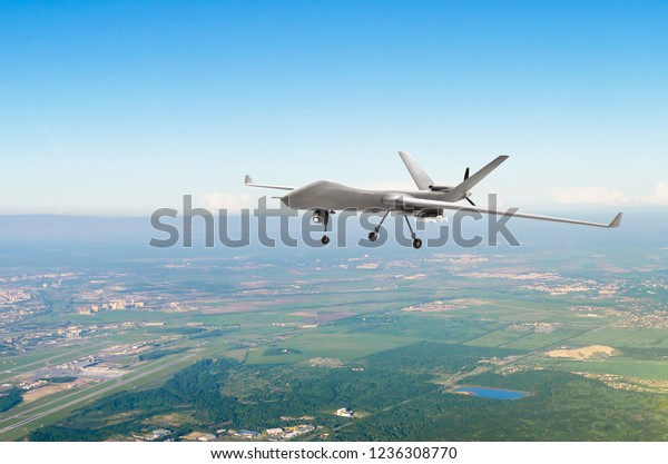 Unmanned military drone uav on patrol air\
territory at low\
altitude