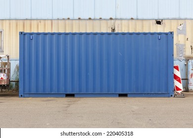 Unmarked Blue Shipping Container At An Industrial Shipyard.