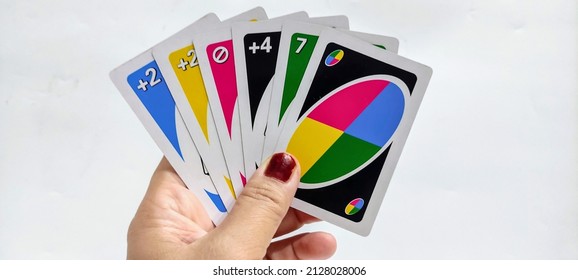 Uno is a colorful card game that includes numbers and symbols. Fun to play with family. Selective focus. 