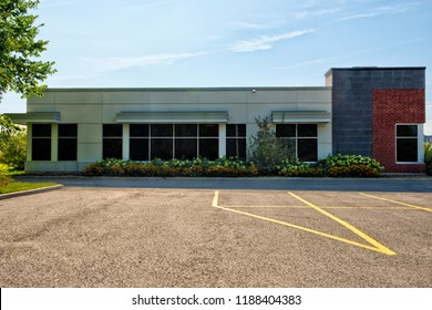 Unoccupied generic store front, business or professional office space. Sunny summer day. - Shutterstock ID 1188404383