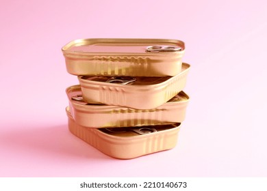 Unopened Sealed Aluminum Tin Cans For Safe With Canned Fish On Pink Background. Long Term Storage Of Food. Steel Sealed Food Storage. Container. Canned Food. 