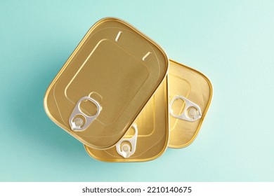 Unopened Sealed Aluminum Tin Cans For Safe With Canned Fish On 
 Blue Background. Long Term Storage Of Food. Steel Sealed Food Storage. Container. Canned Food. Top View. Flat Lay