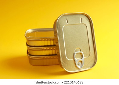 Unopened Sealed Aluminum Tin Cans For Safe With Canned Fish On Yellow Background. Long Term Storage Of Food. Steel Sealed Food Storage. Container. Canned Food. 